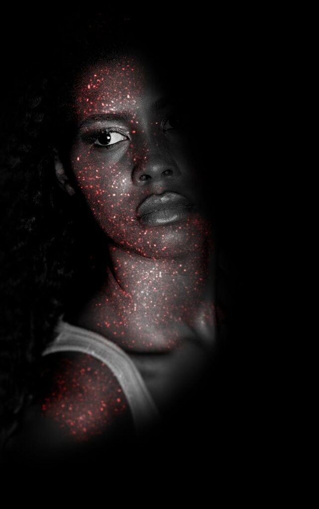 Creative portrait of a woman with sparkling glitter effect enhancing facial features.